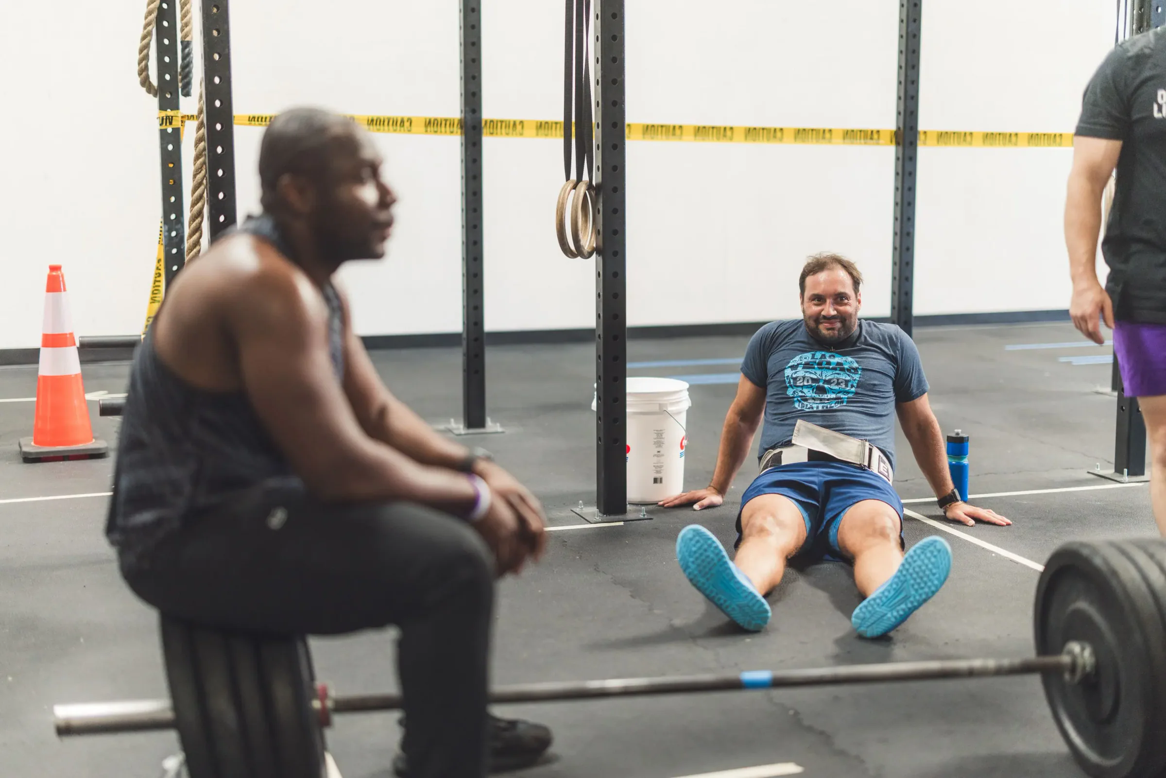 A One Life coach supporting an athlete during strength training