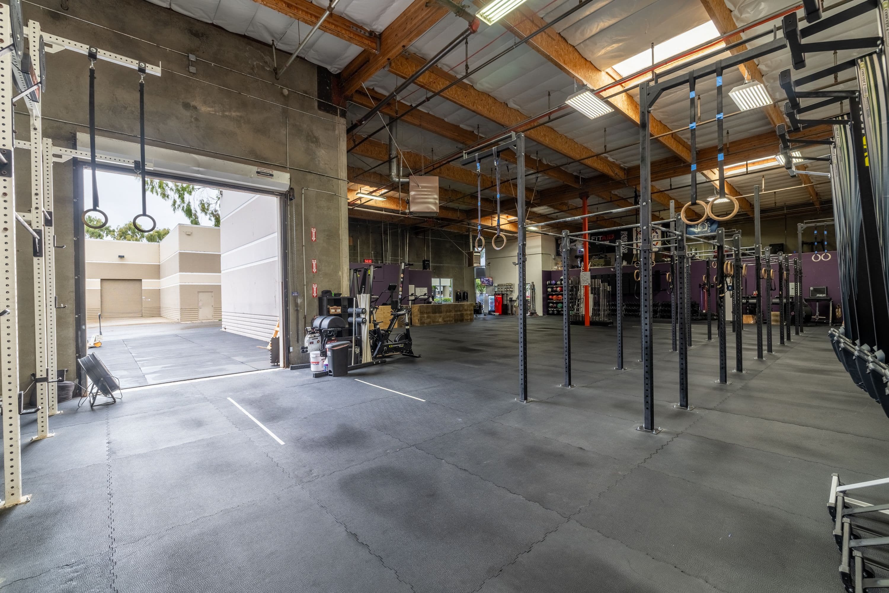 Open garage door and spacious training floor at One Life CrossFit