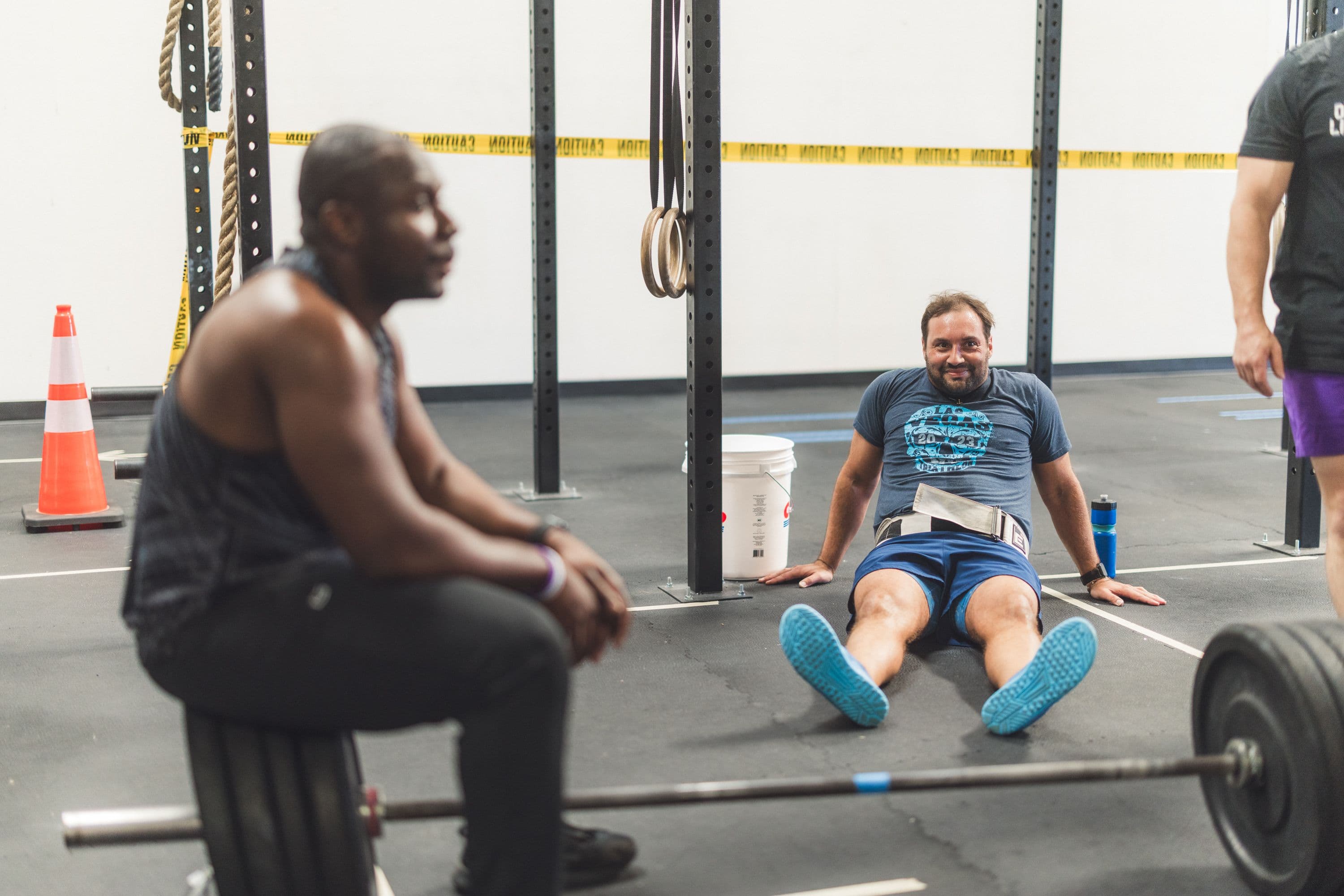 A One Life coach supporting an athlete during strength training